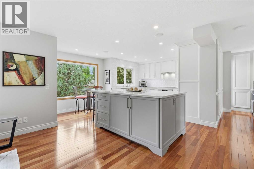 VIEW TO KITCHEN  - naturally lit with gorgeous new triple pane windows, loads of pot lights and undercab lighting