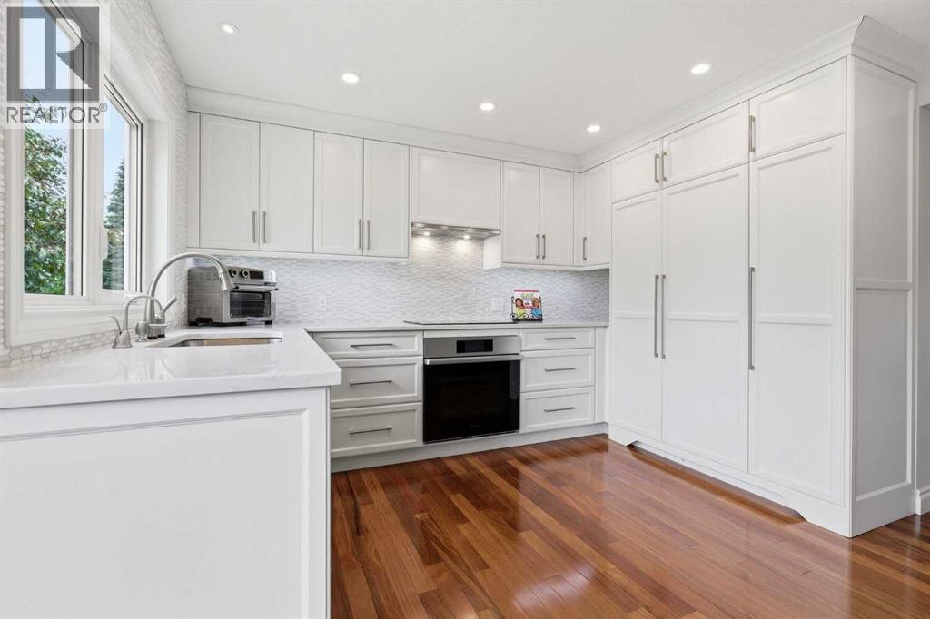 KITCHEN  - a stunning kitchen offers Miele appliances. The fridge is camouflaged beneath the sleek new panels. Full height cabinetry maximizes the storage, soft close doors and drawers throughout