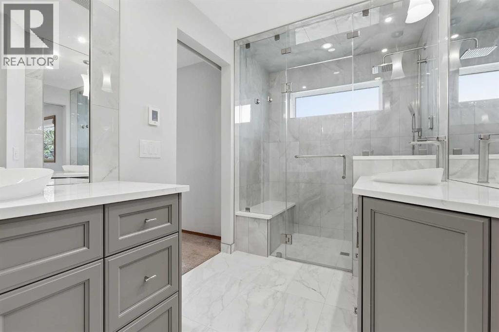 FOUR PIECE ENSUITE  boasts dual vanities, quartz topped counters, soft close drawers, full height mirrors, and a GORGEOUS STEAM SHOWER complete with bench