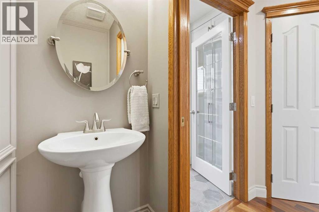 TWO PIECE POWDER ROOM  - set in shades of soft grey and tucked away from the main living area to maximize privacy