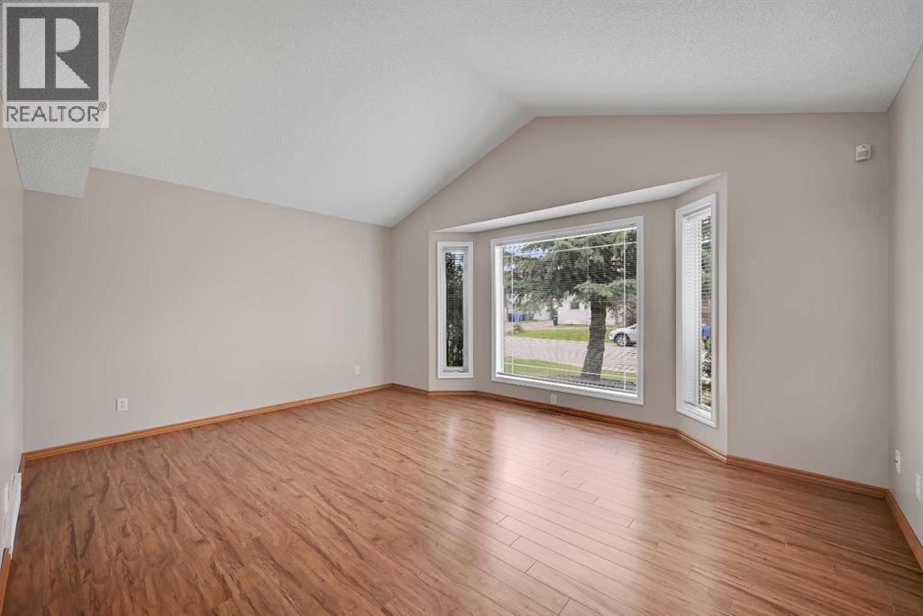 The FRONT room with the VAULTED ceiling is a stunner! EAST facing bay window onto the quiet street