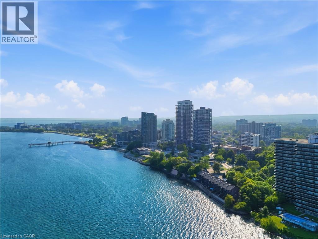 Waterfront cityscape featuring contemporary high-rise buildings and expansive blue waters