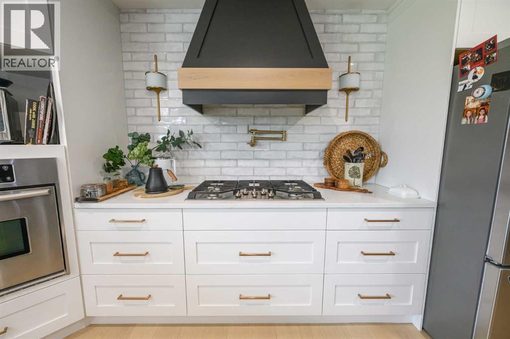 gas stove top, pot-filler,  canopy rangehood,  built-in wall oven
