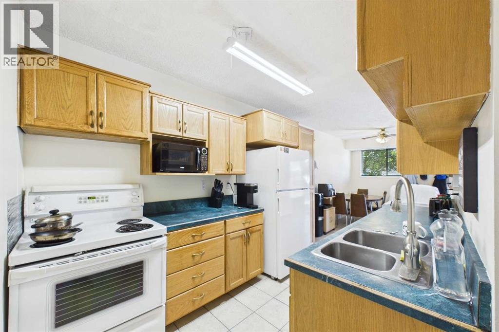 Kitchen 8'x 15'4", Amana Fridge, Electric Stove, Amana Dishwasher, RCA Microwave, Tile Floor, Laminate Countertops