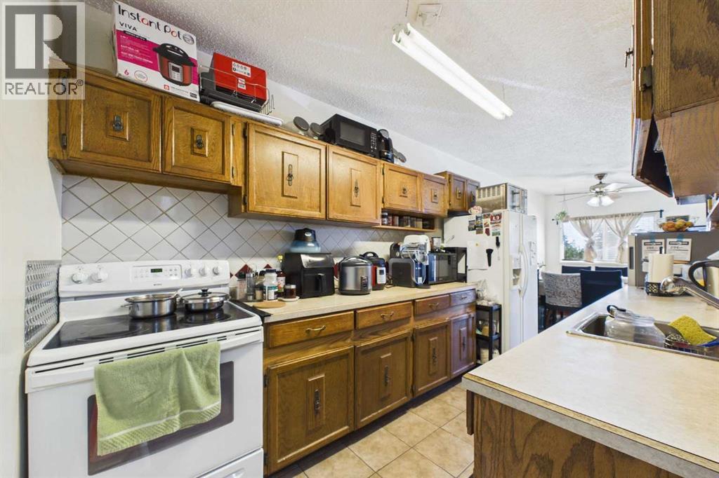 Kitchen 8'7"x15'4",  12" Tile Floor, Electric Range, Inglis SxS Refrigerator, Panasonic Microwave, Laminate Countertops with Beveled Edge