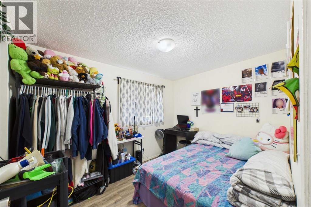 #2 Bedroom(SW corner) 12'1"x 11'11", West Vinyl window with curtain, LVP flooring, Mirrored closet doors
