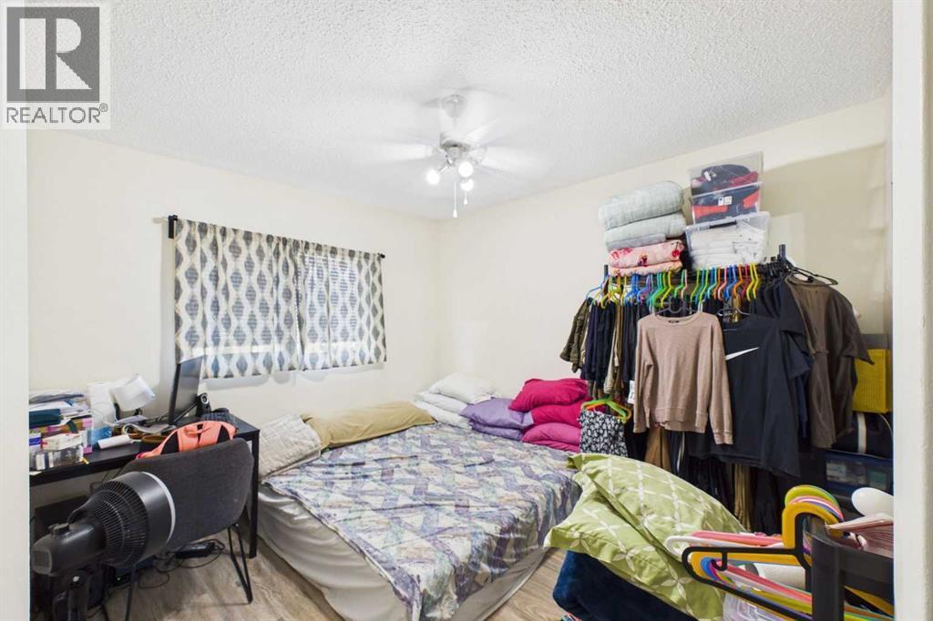 Primary Bedroom 12'1x11'11",  West Vinyl Window with Curtain Covering, Ceiling Fan, LVP flooring, Mirrored Closet Doors