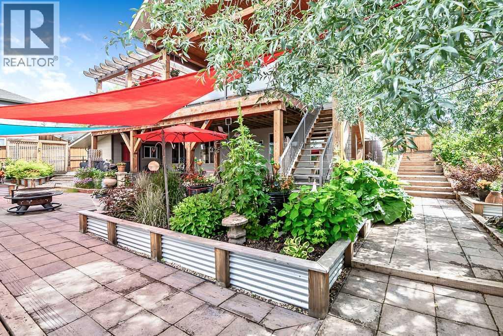 Lush gardens and mature trees grace the yard
