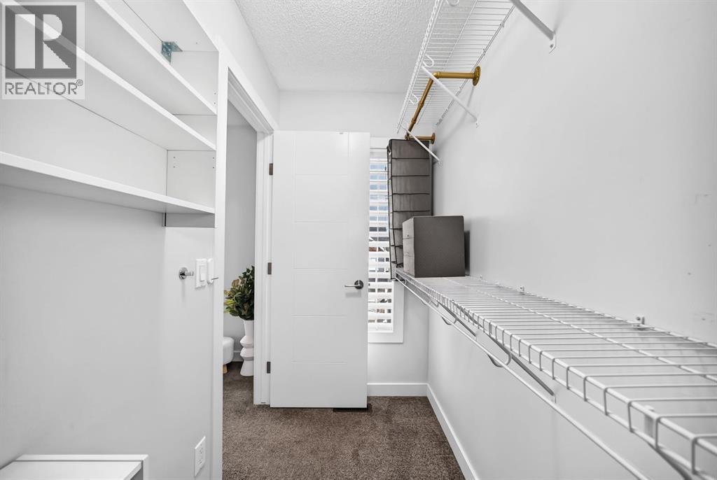 Large walk-in closet with extra shelving and a window!