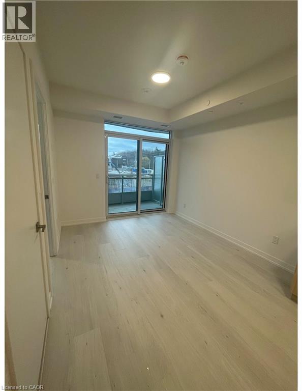 Bright room featuring wood-finish flooring and a private balcony