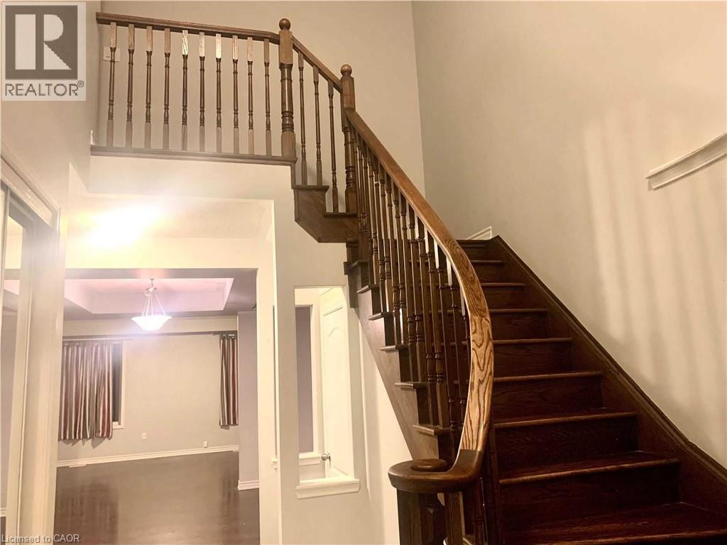 Grand staircase featuring dark wood treads and banister