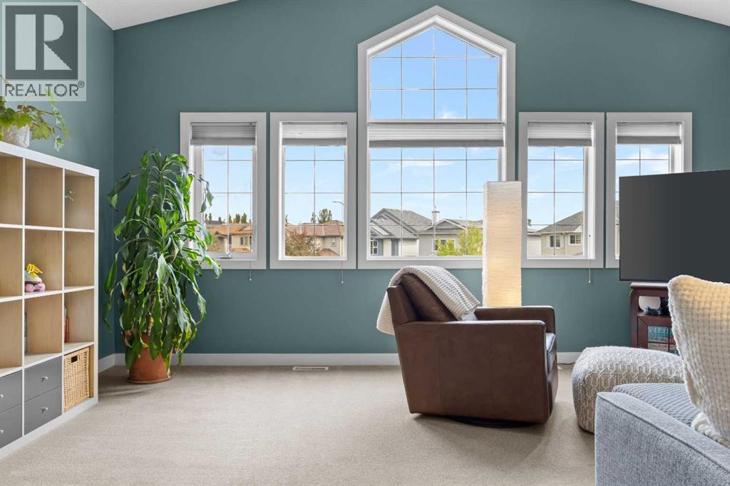 Upstairs, the vaulted bonus room faces front and fills beautifully with natural light — the kind of space that quietly becomes whatever your family needs it to be