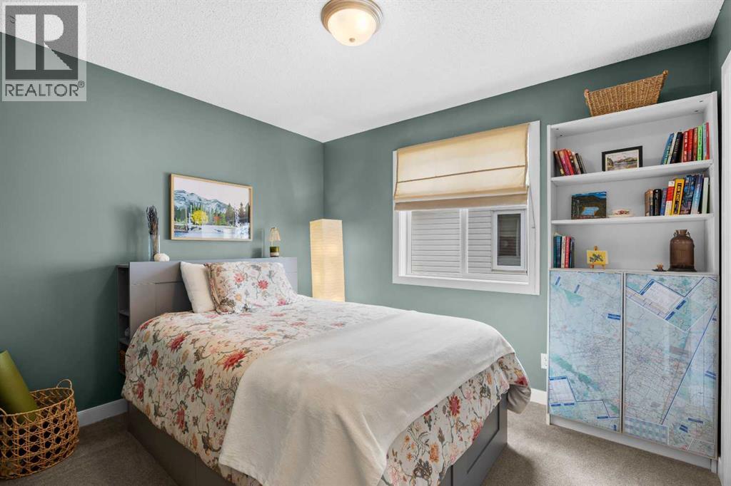 The second bedroom is bright and generously sized, with room for a full bed, bookshelves, and a personality all its own