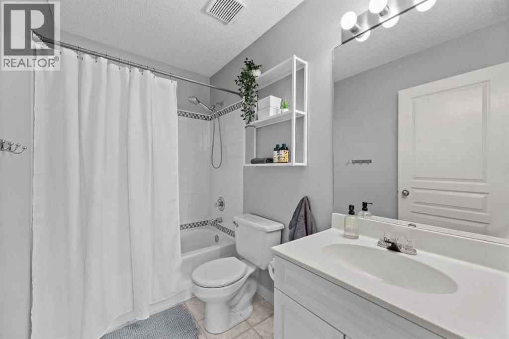 A crisp 4-piece bathroom serves the two additional bedrooms — bright, clean, and ready for the morning rush