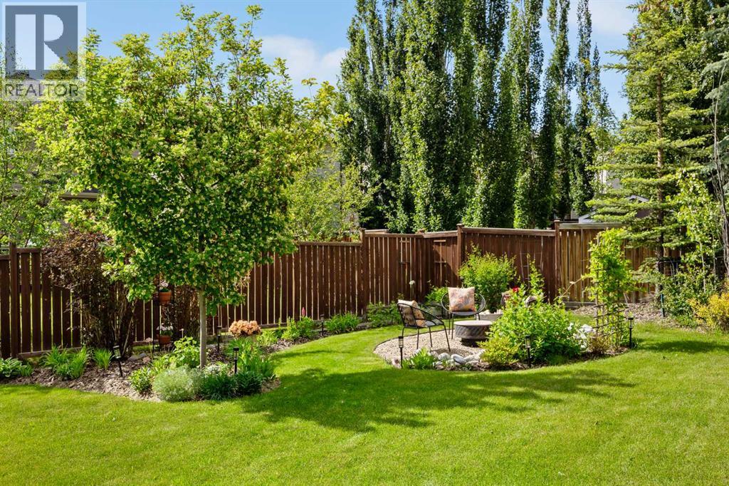 This yard has been loved, and it shows in every corner — curated garden beds, mature trees, and landscaping that hands you a decade's head start