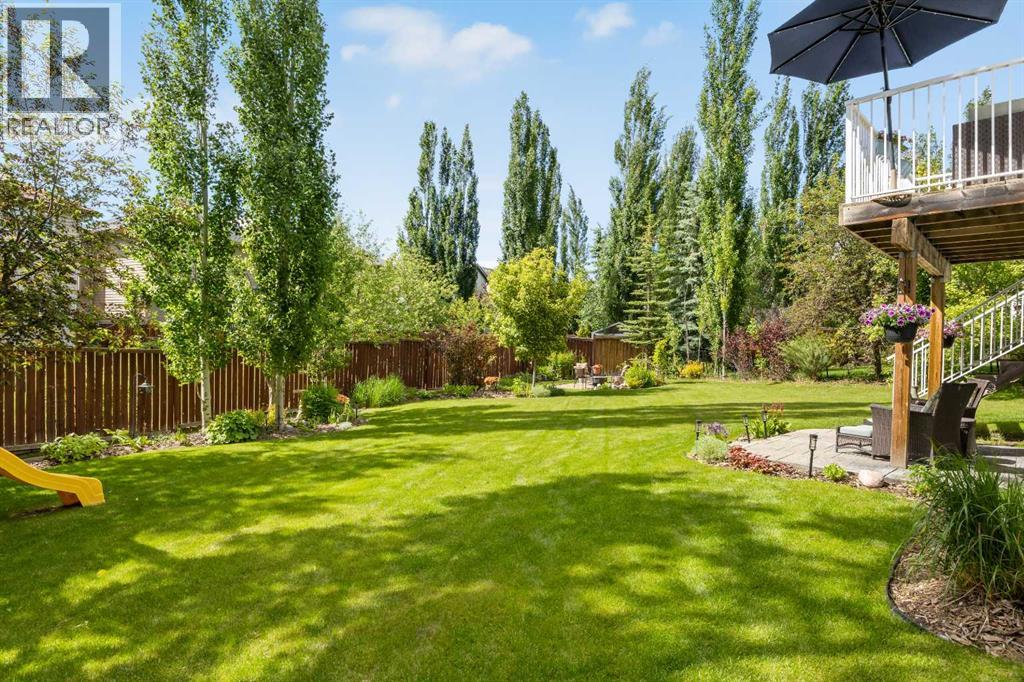 Here's the pie-shaped lot doing what it does best — a sweeping lawn that has hosted more than a few slip-and-slides, yard games, and BBQs worth remembering