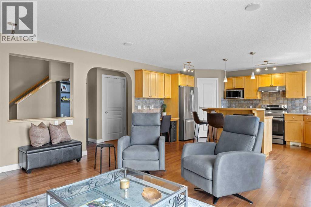 The main floor flows effortlessly from living room to kitchen — an open layout designed around how a family actually lives, where whoever's cooking is never left out of the conversation