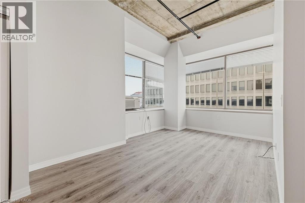 Room with concrete ceiling and exposed conduit