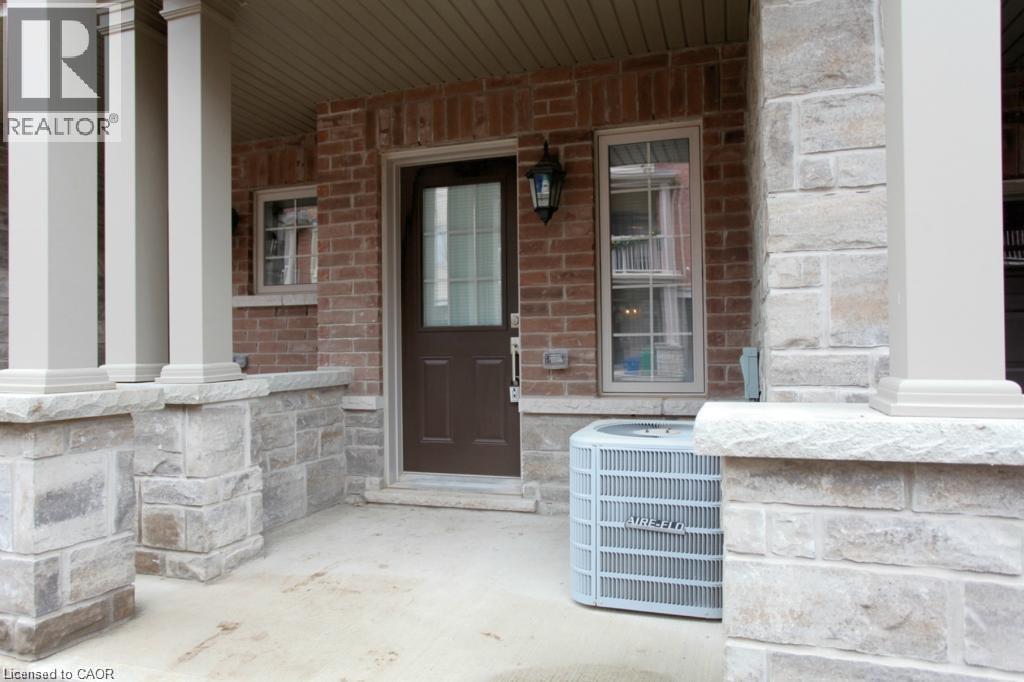 Covered front porch featuring brick and stone veneer siding
