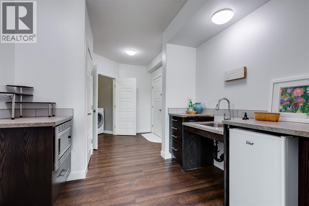 Kitchenette set up in the basement with room for a full sized fridge and dishwasher