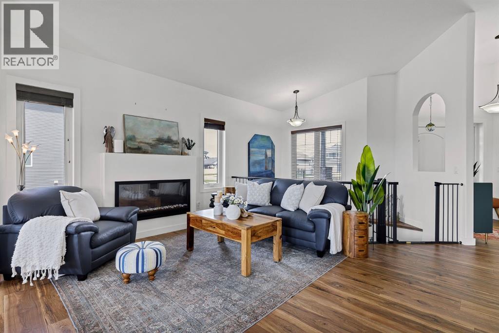 Spacious living room with upgraded railings and cozy fireplace