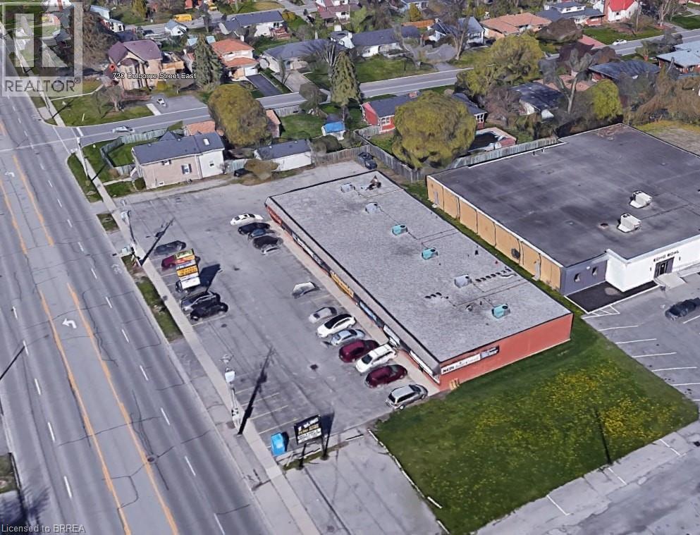 Commercial building with extensive paved parking, red-painted exterior, and a flat roof