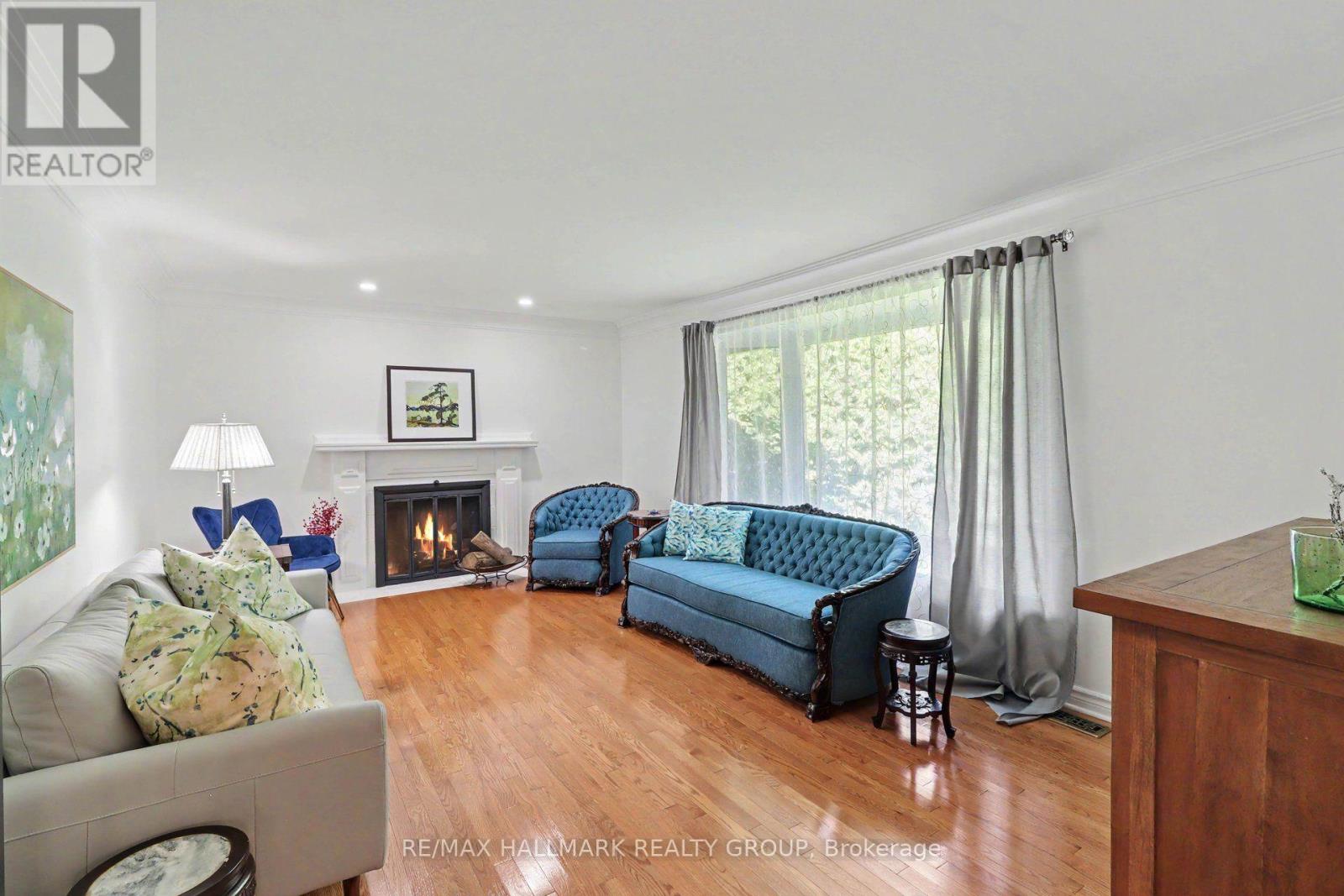 Elegant fireplace, hardwood floors, natural light.