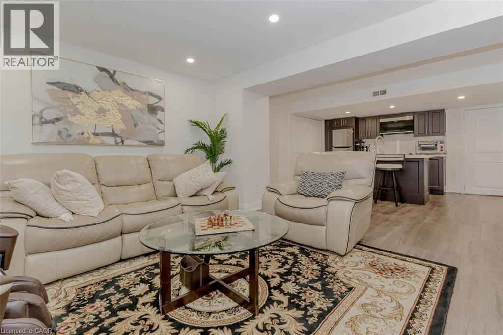 Open-concept living space with light wood-finish flooring, recessed lighting, and a neutral wall palette