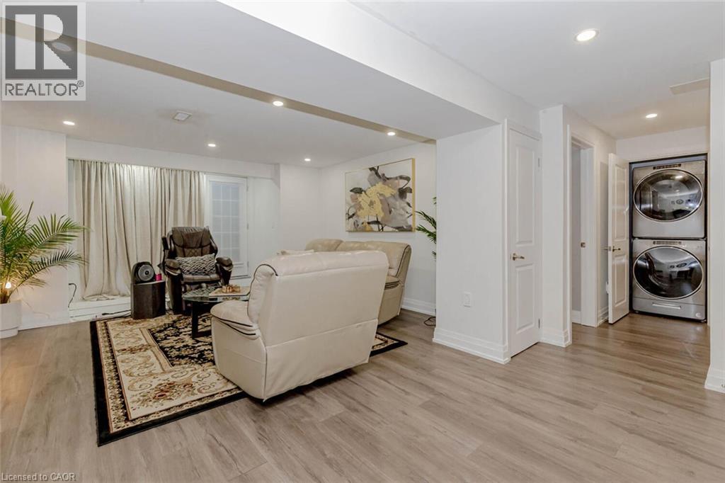 Spacious living area featuring wood-finish flooring, recessed lighting, and a sliding glass door