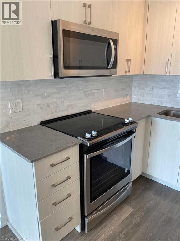 Kitchen featuring stainless steel appliances including a range and over-the-range microwave