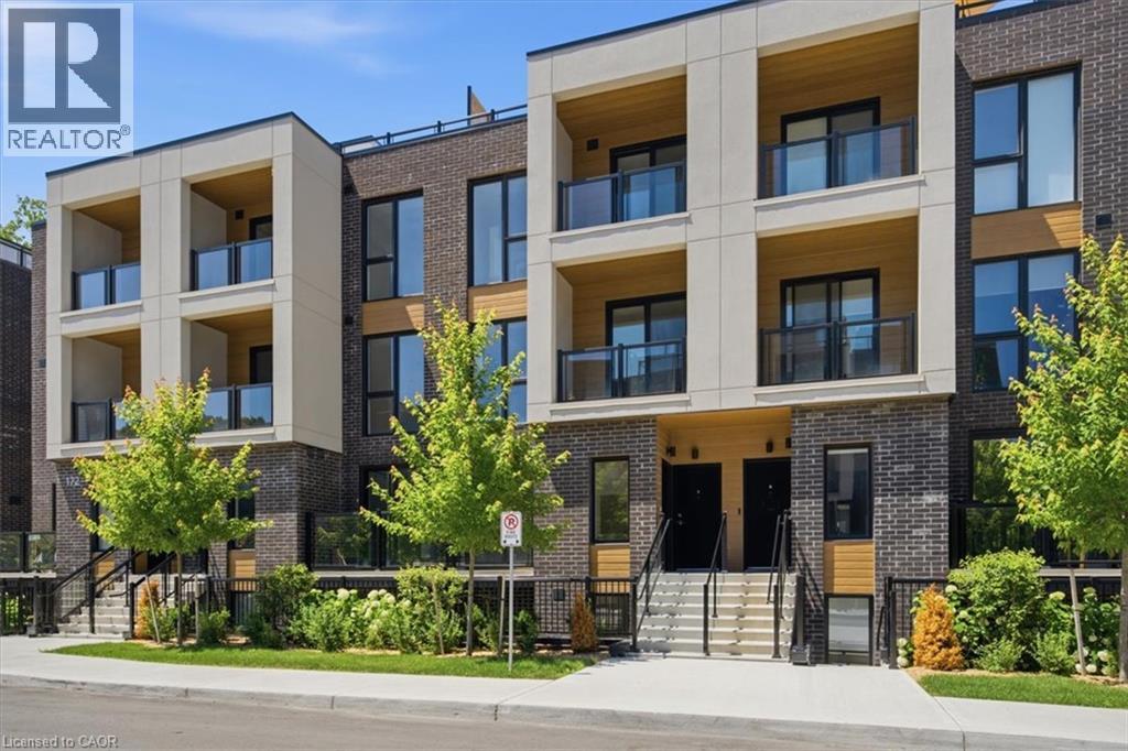 Contemporary townhome exterior featuring multi-level balconies with glass railings