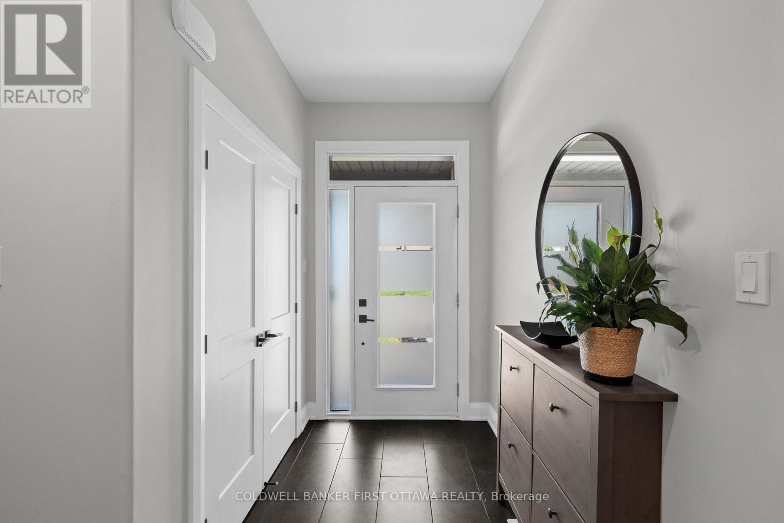 Tiled front foyer w dbl door hall closet.