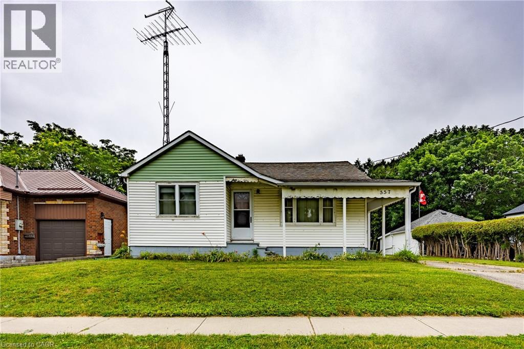 Single-story residence featuring white siding and a green gable accent