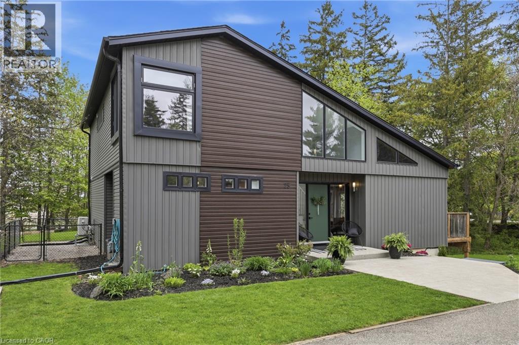 Modern exterior featuring contrasting horizontal and vertical siding, an asymmetrical roofline, and a prominent front entry with a light green door