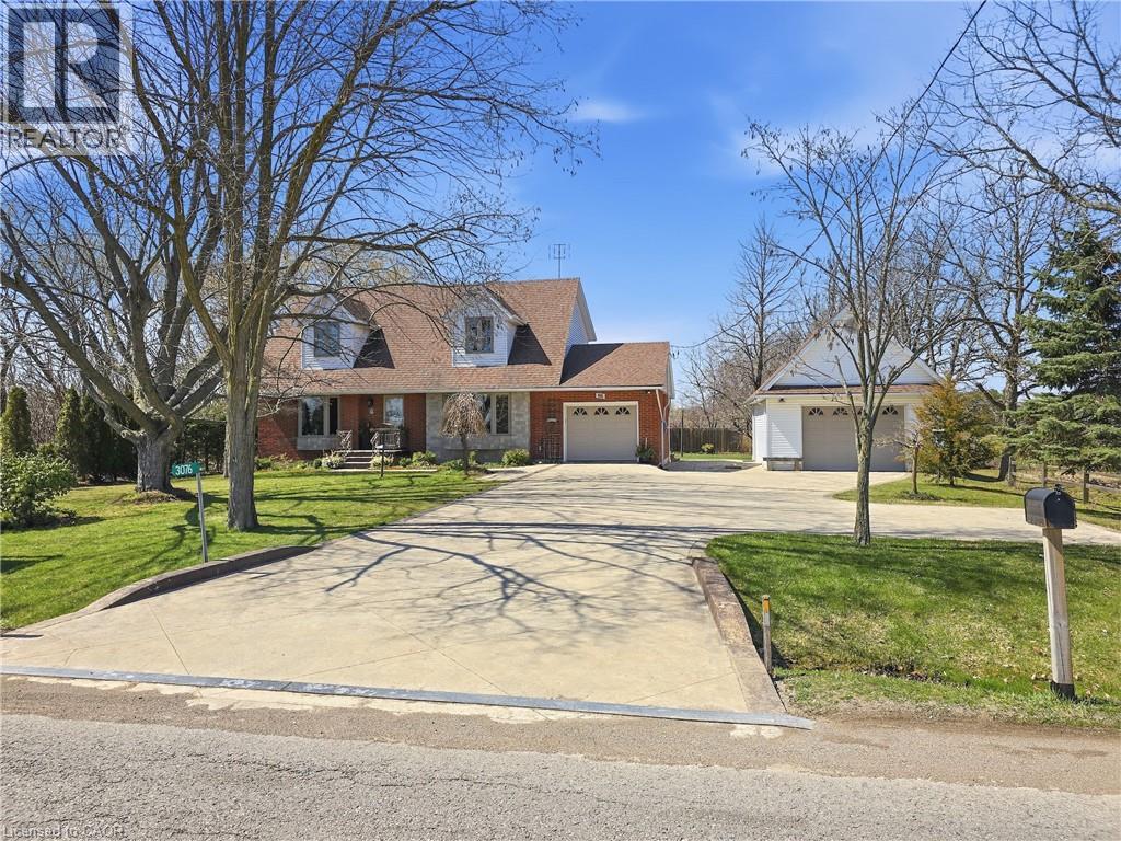 The property features a brick and stone facade, a brown roof, and multiple dormer windows