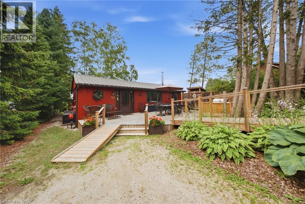 Red exterior residence with a metal roof and an expansive wood deck