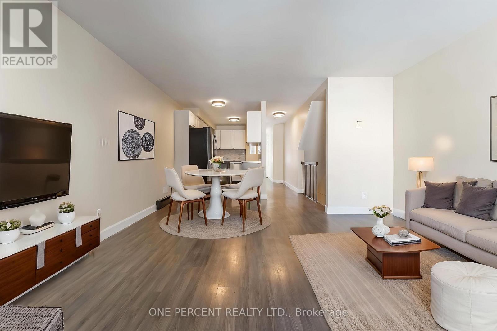 Living room overlooking digitally staged dining rm