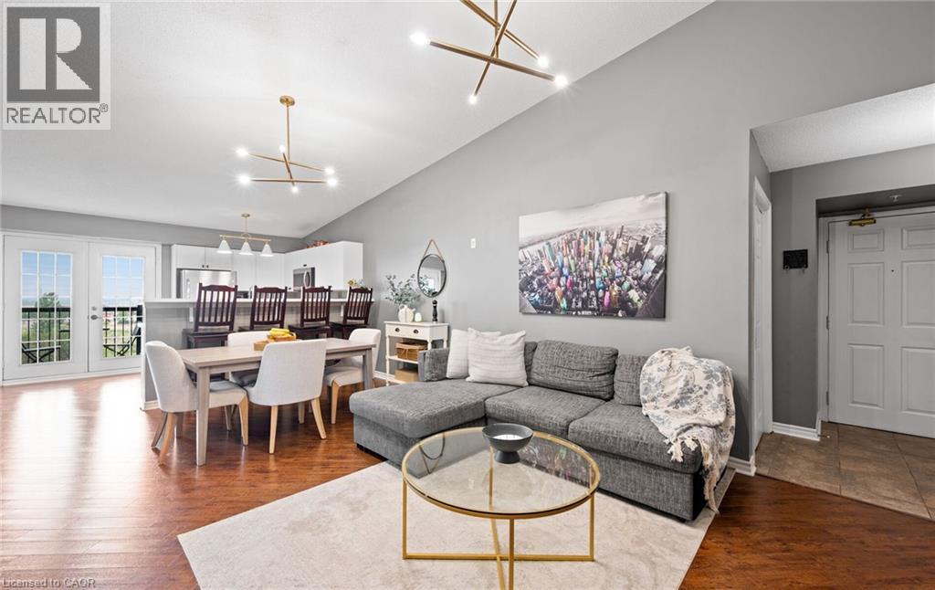 Expansive open-concept living area featuring wood-finish flooring and a vaulted ceiling