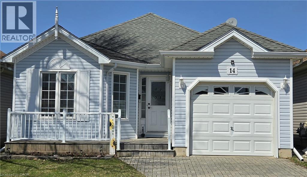 View of front facade with a garage, driveway, and roof with shingles