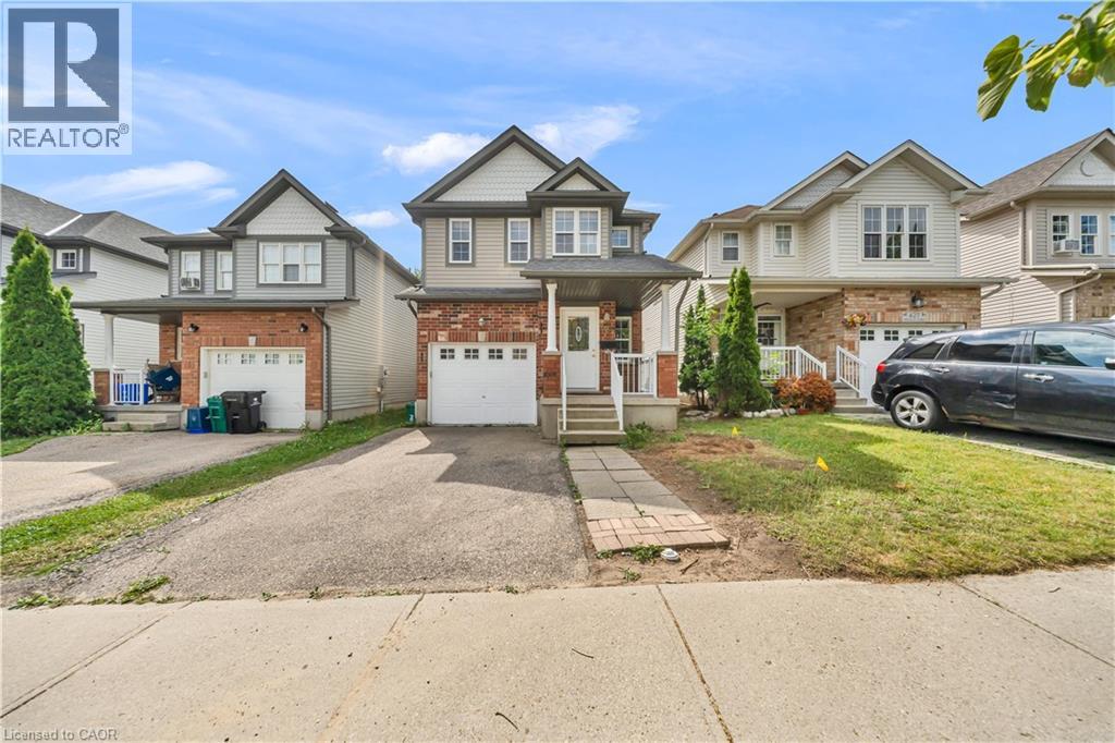 Two-story residence featuring a brick and siding exterior, an integrated single-car garage, and a paved driveway