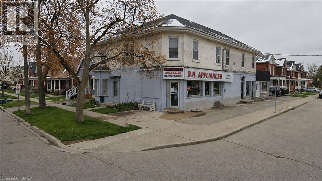 Corner property featuring a mixed-use commercial and residential building with a brick facade