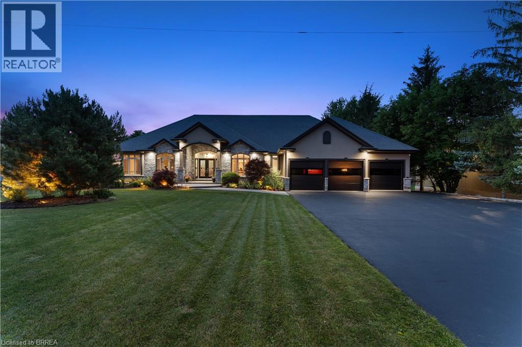 Stone and stucco exterior with a three-car garage