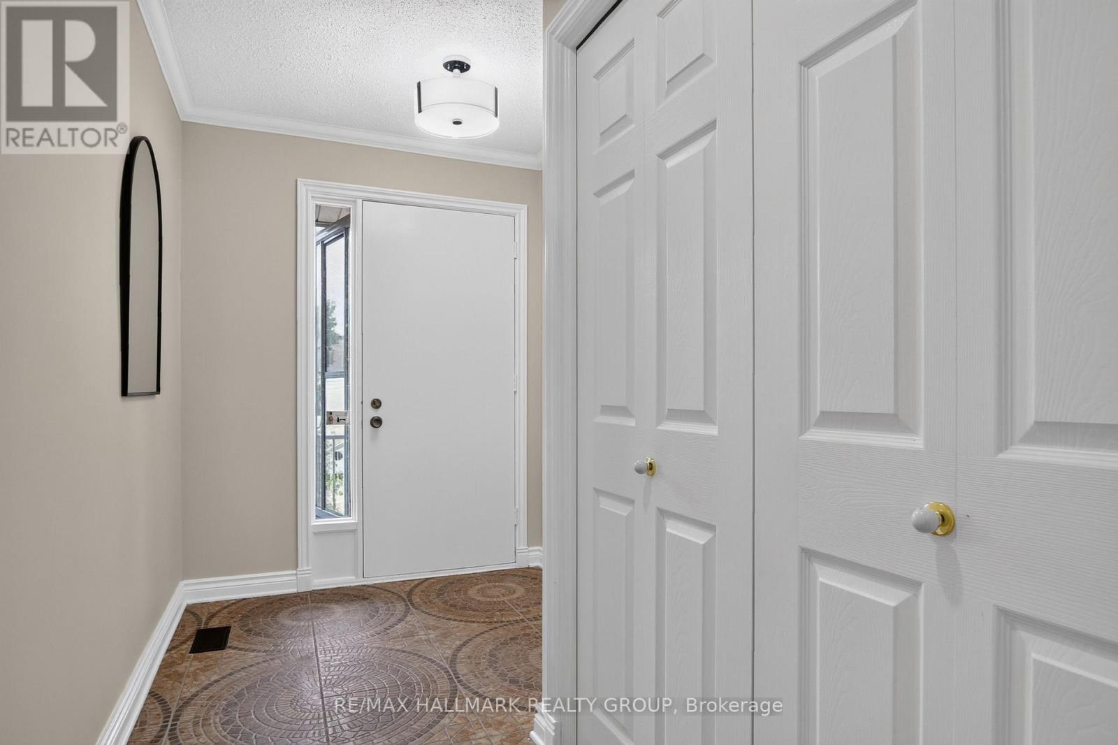 Double coat closet in spacious tiled foyer.