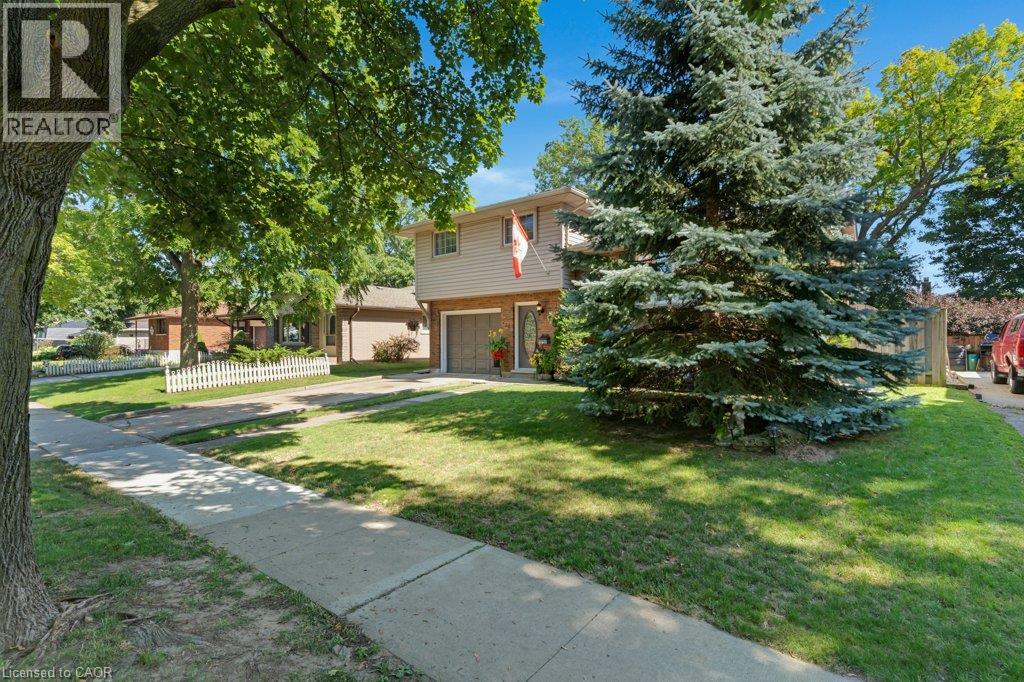Two-story residence with brick and siding exterior, attached garage, and a concrete driveway