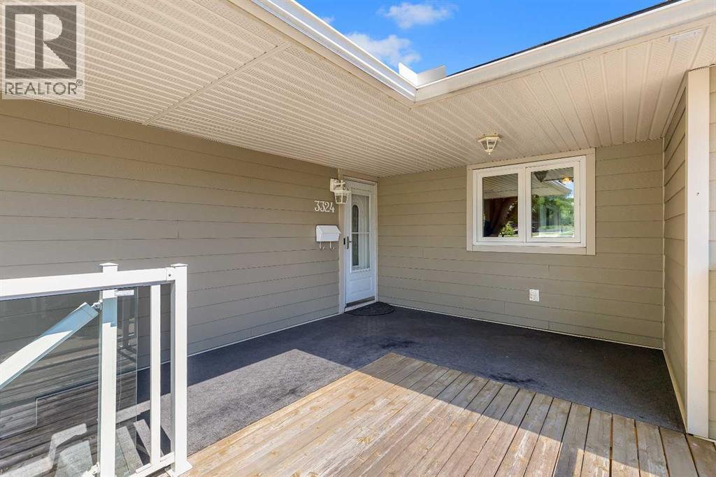 front deck with glass railing , facing to  green space,