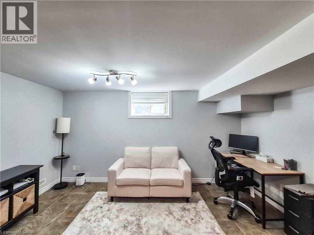 Spacious room featuring light gray walls, a window with blinds, and recessed lighting