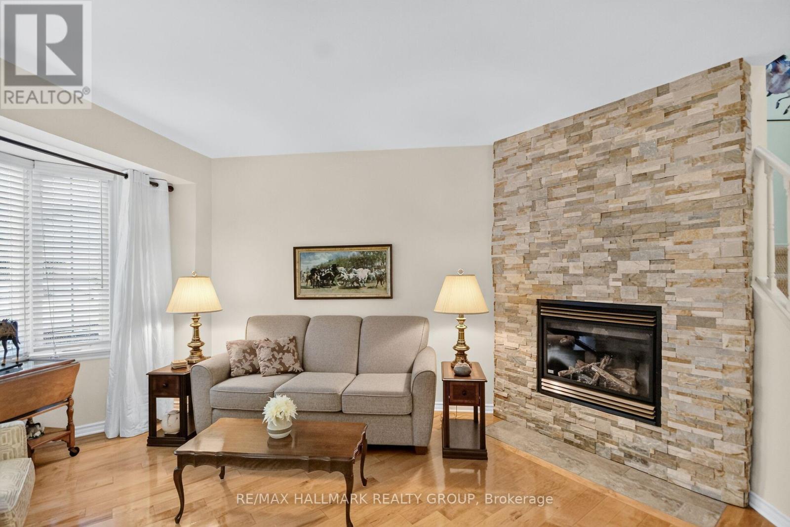 Spacious living room with stone wall gas fireplace