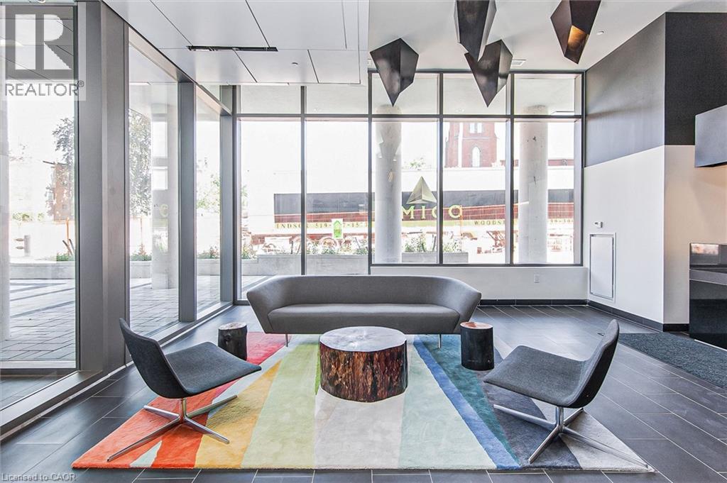 Lobby area featuring floor-to-ceiling windows, dark tile flooring, and a modern ceiling design