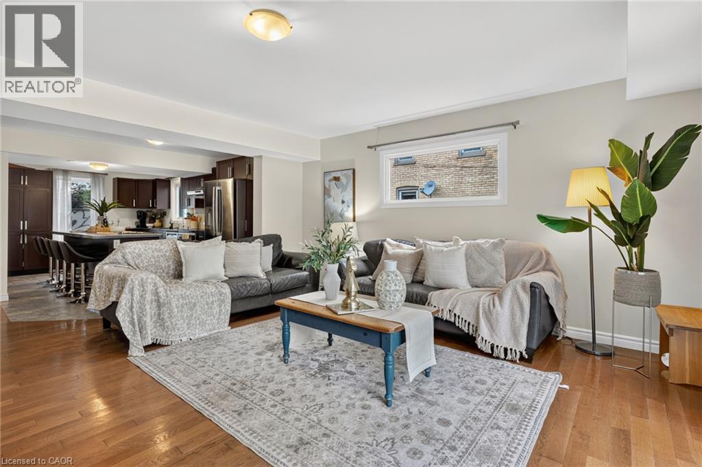 Hardwood flooring throughout, recessed lighting, and a modern kitchen island with built-in seating