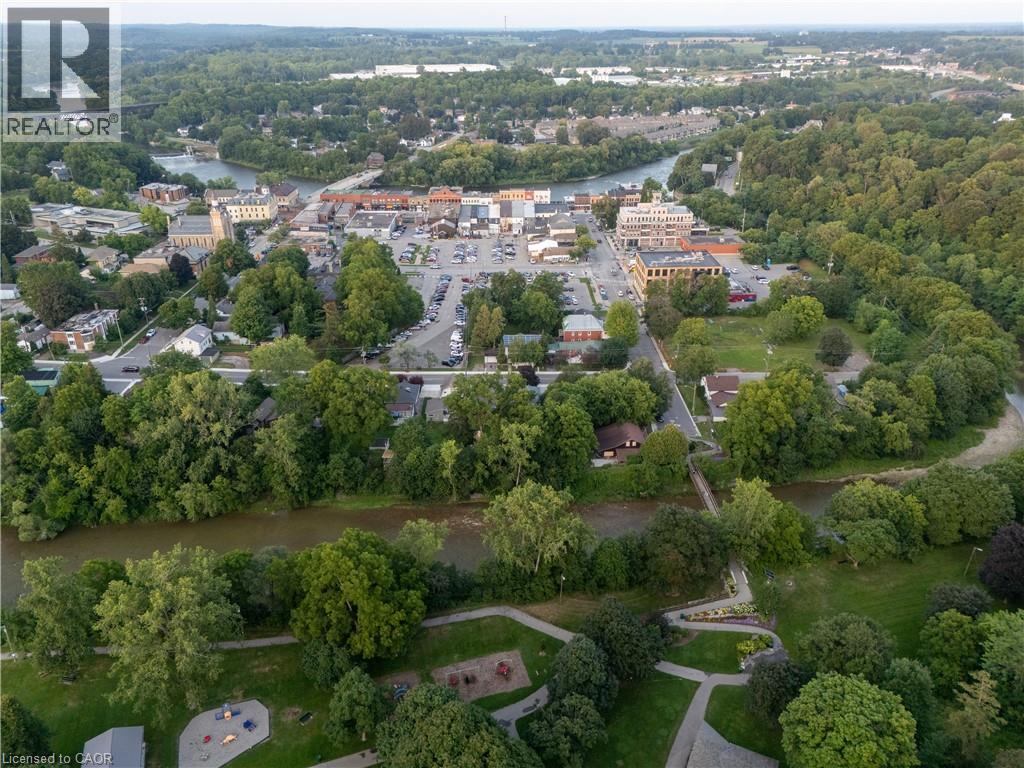 Park setting with a river, natural landscape, and municipal structures